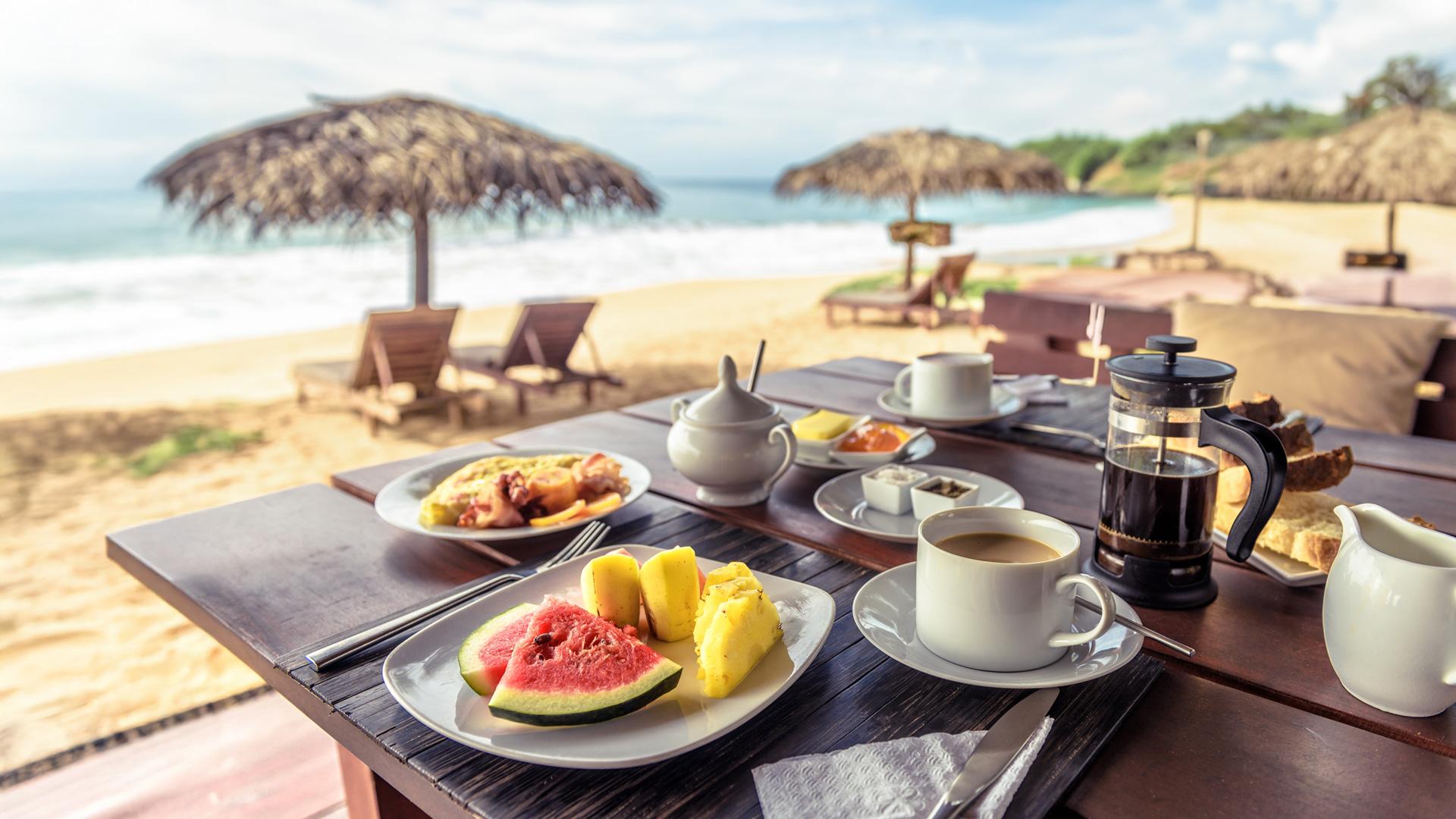Down south, breakfast is served on a table by the beach.