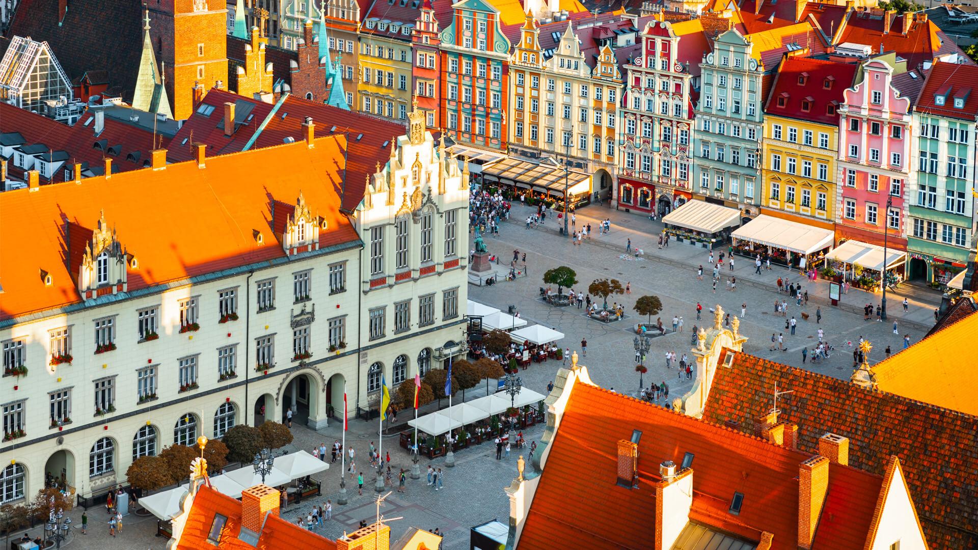 Aerial view of Wrocław’s Market Square, lined with pastel-coloured buildings and ornate gabled facades.