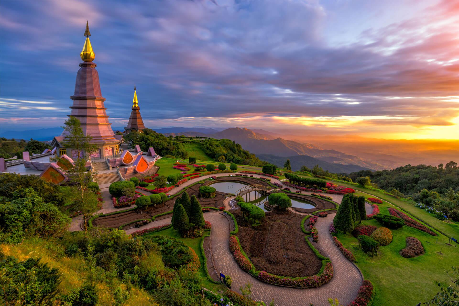 Buddhist pagodas at Doi Inthanon in Chiang Mai, Thailand, perched on a mountain and surrounded by colourful gardens.
