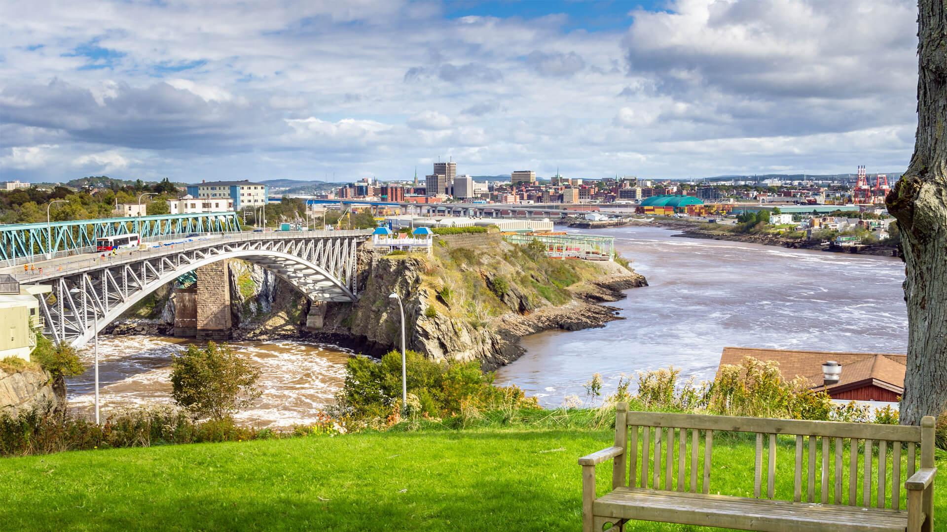 View of Saint John, New Brunswick, featuring the Reversing Falls Bridge, the Saint John River, and the city in the background.