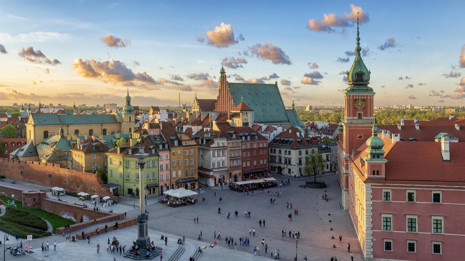 Warsaw’s Old Town at sunset, with Castle Square, the Royal Castle, and colourful historic buildings, in Poland.